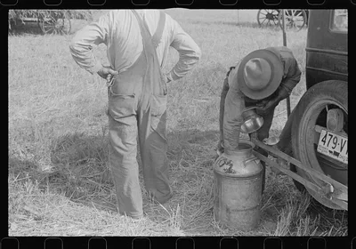 Member of threshing crew getting a drink, central, Ohio, 1938