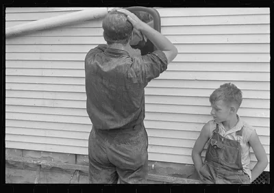 Getting ready for dinner during wheat harvest, central Ohio, 1938