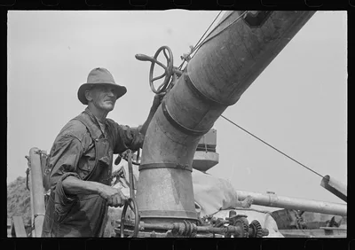 Adjusting straw stacker or grain separator, Ohio, 1938