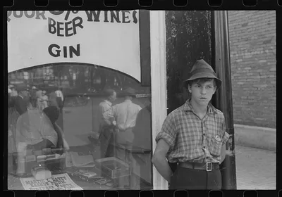 Boy in front of liquor store, Newark, Ohio, 1938
