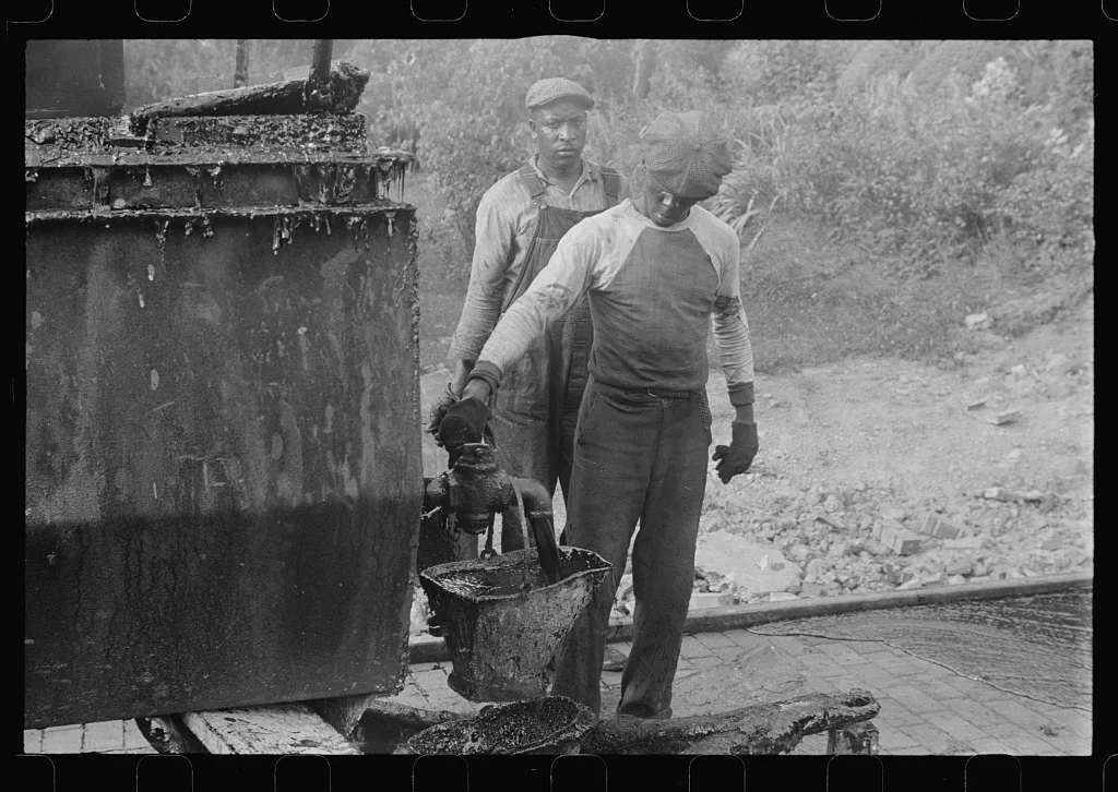 Workers repairing Route 40, central Ohio. Vat for heating tar used in…, 1938