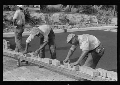 Special laborsaving rollers used in moving brick for road repair,…, Ohio, 1938