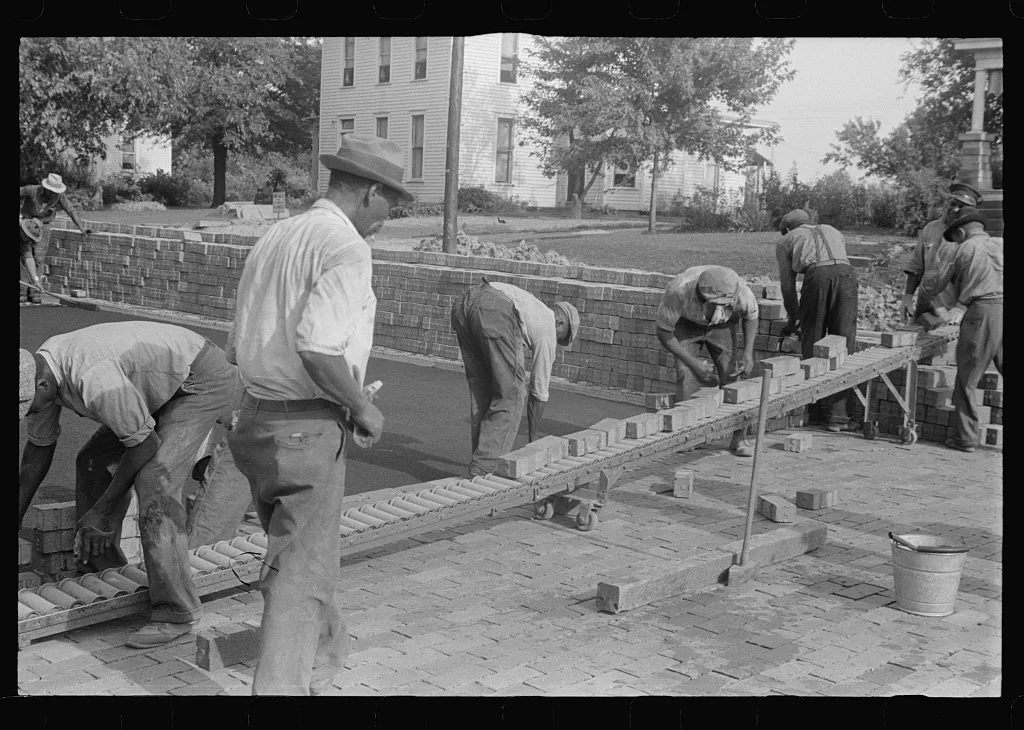Special laborsaving rollers used in moving brick for road repair,…, Ohio, 1938