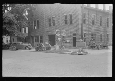 The backyard of this gas station is a farm machinery graveyard,…, Ohio, 1938