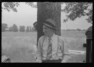 Spectator at farmland auction, New Carlisle [i.e. Marysville], Ohio, 1938