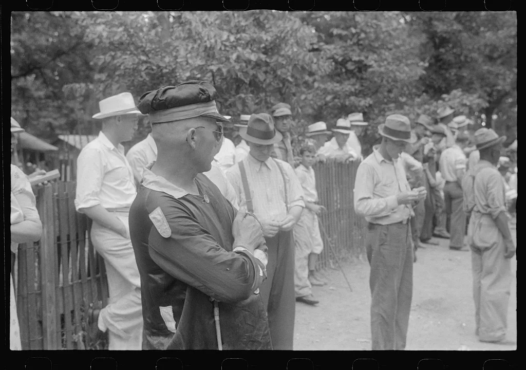 Spectators and clocker at county fair in central Ohio, 1938