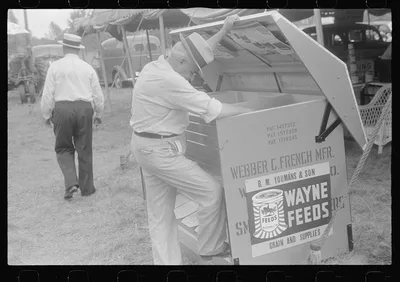 Attendant at farm machine display, county fair, central Ohio, 1938