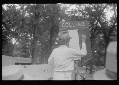 Chalking up race results at county fair in central Ohio, 1938