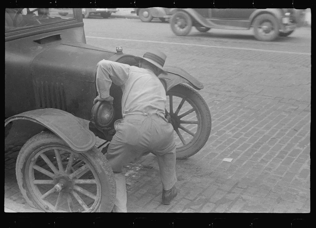 Cranking car to get it started, the old way, Worthington, Ohio, 1938