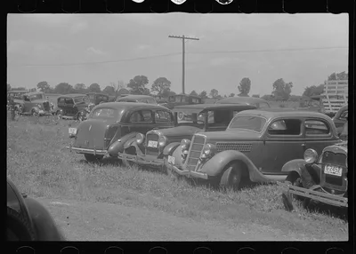 Farmers' cars parked outside of public auction, central Ohio, 1938