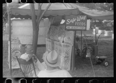 Advertising feeds at county fair, central Ohio, 1938