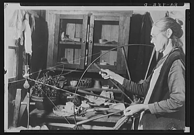 Woman running spinning wheel at Crossville, Tennessee. Cumberland…, 1935